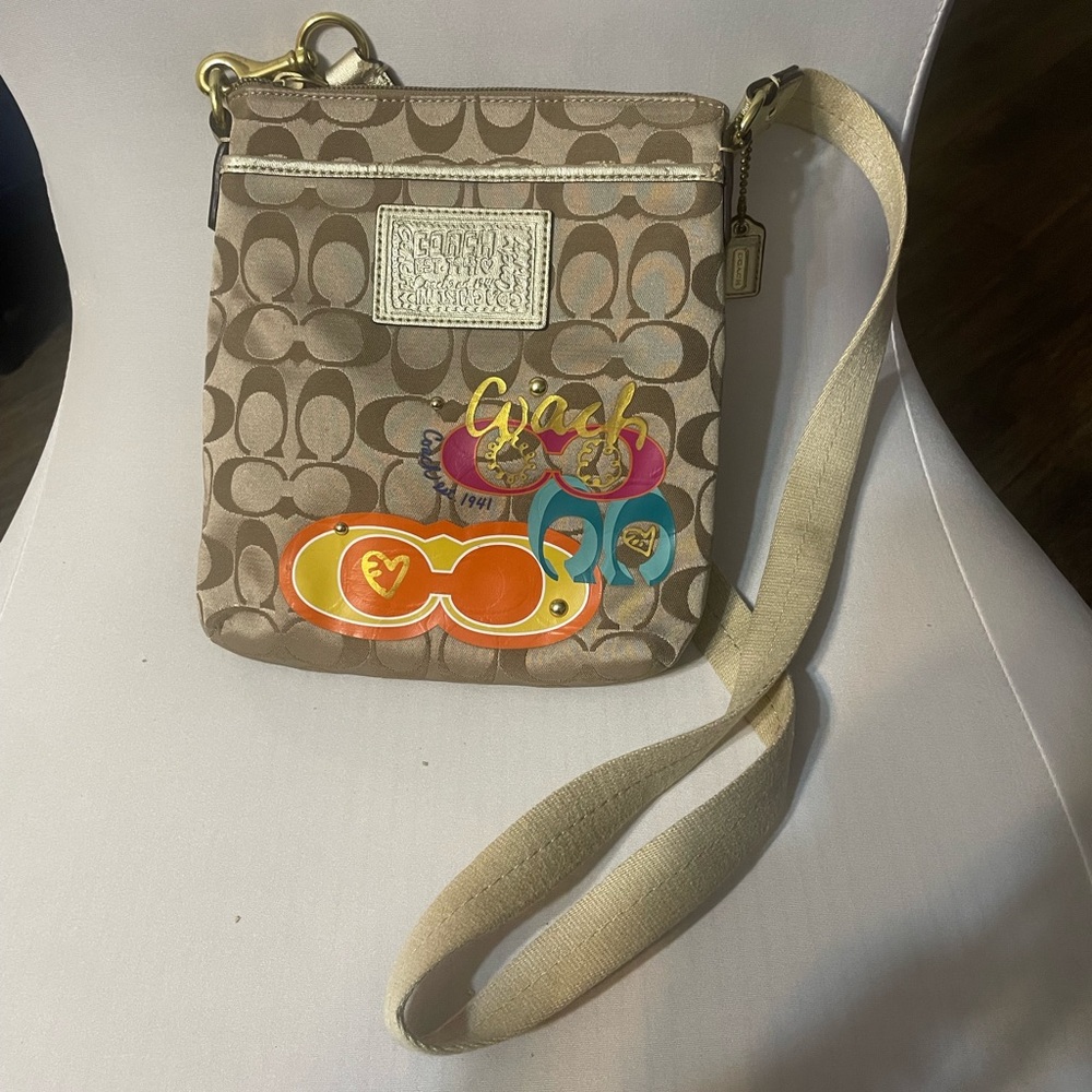 Coach Poppy Signature Canvas Crossbody bag with a colorful graphic print discon